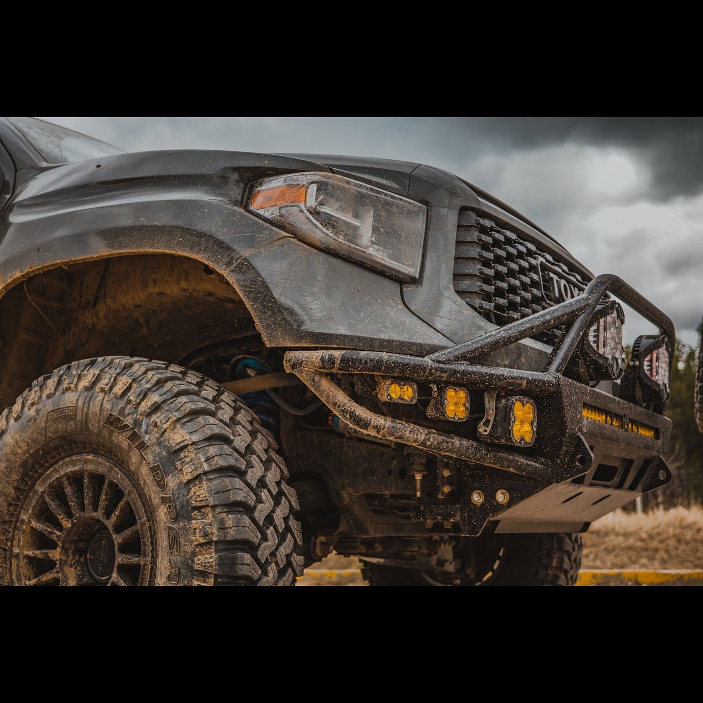 Quartering side angle showing the C4 Hybrid bumper for the 2014+ Toyota Tundra installed on a widebody-modified truck.