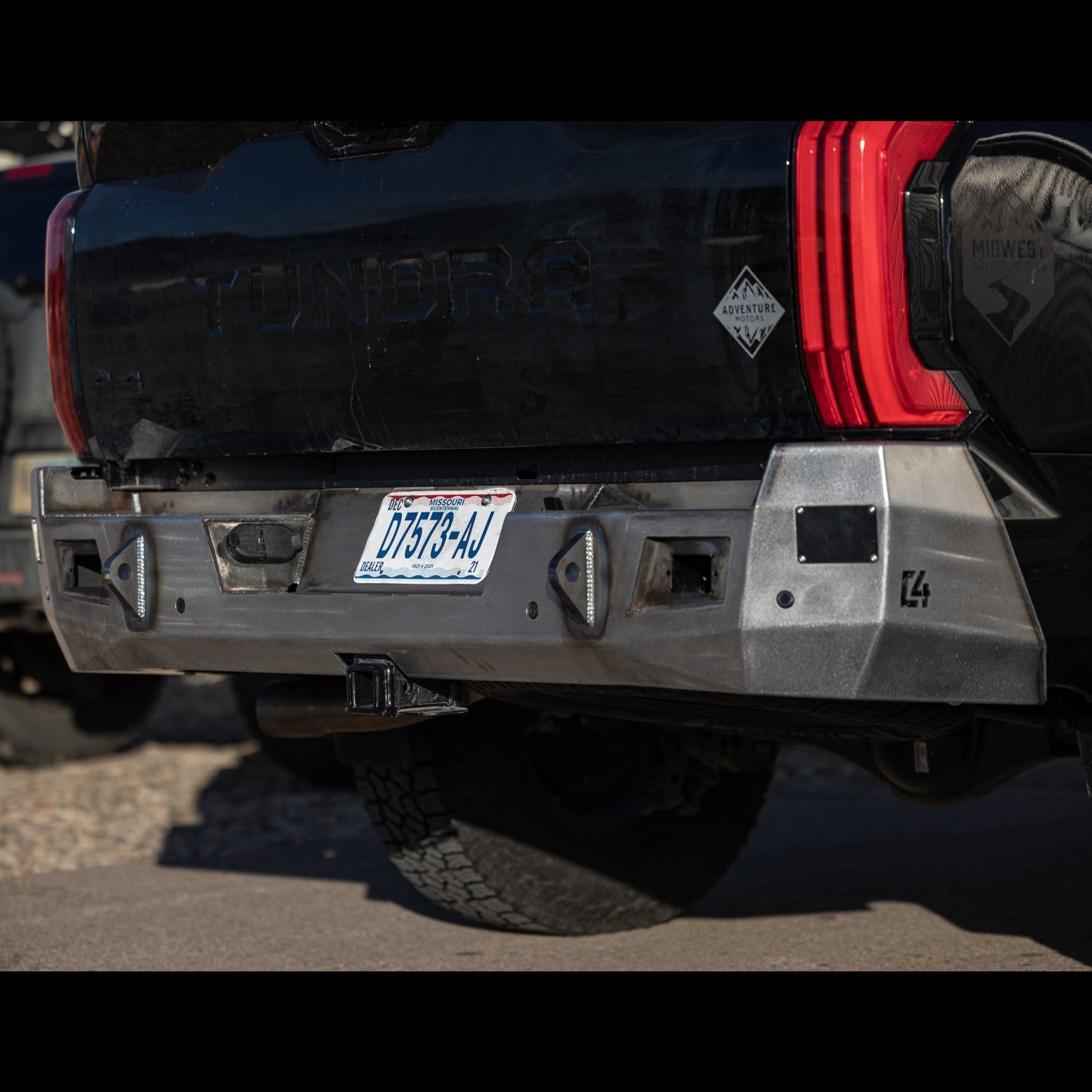 Photo taken from a low angle showing the many facets of the C4 Overland bumper for the 3rd Gen Toyota Tundra, displayed in the raw steel finish that all C4 bumpers ship to customers in.