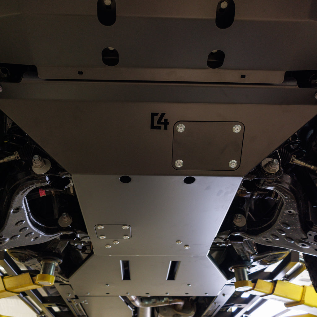 View from below of the C4 full skid plate set installed on a 2024 Land Cruiser LC250.