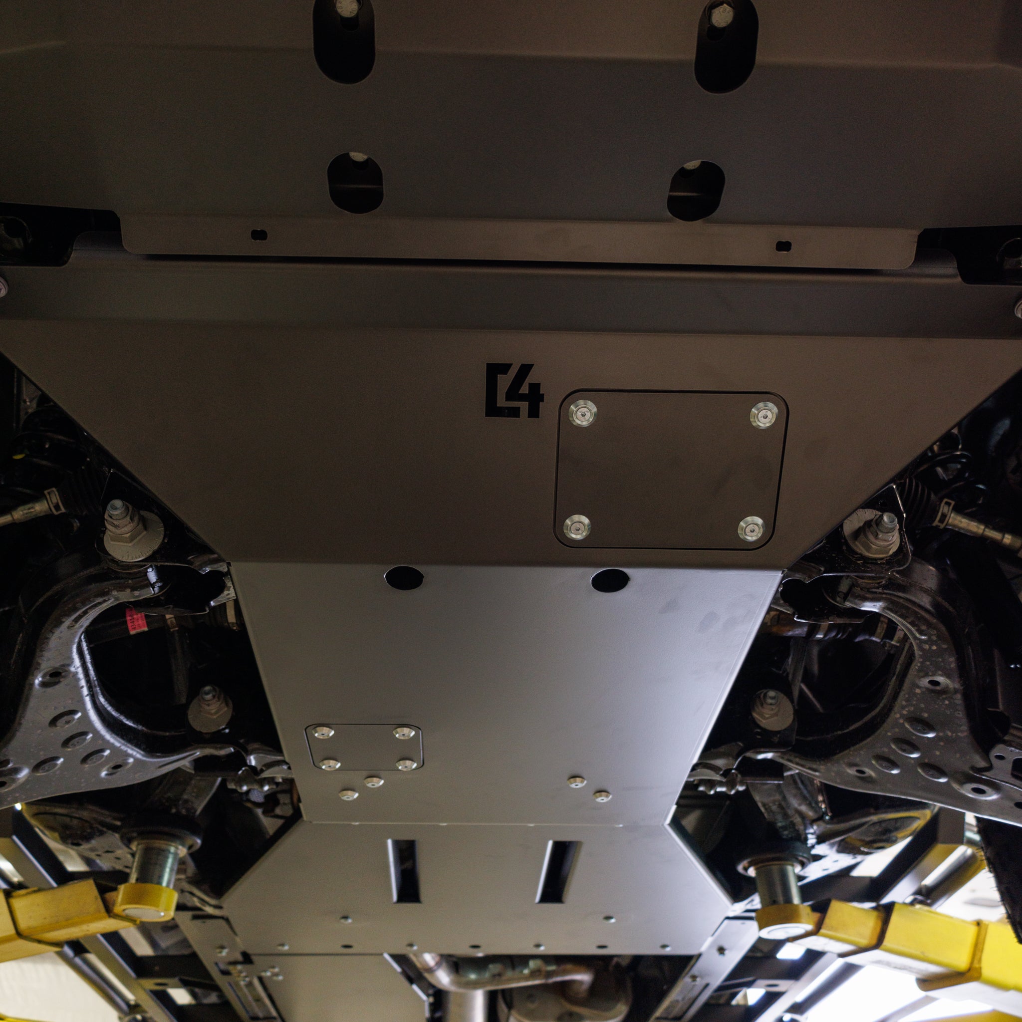 View from below of the C4 full skid plate set installed on a 2024 Land Cruiser LC250.