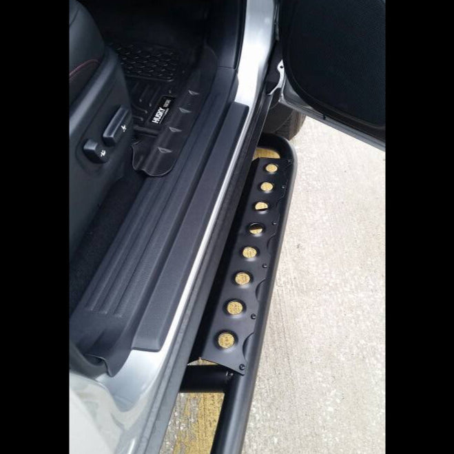 View from top-down of the open passenger door showing the optional side step installed on a set of C4 Fabrications rock sliders for the Toyota 4Runner.