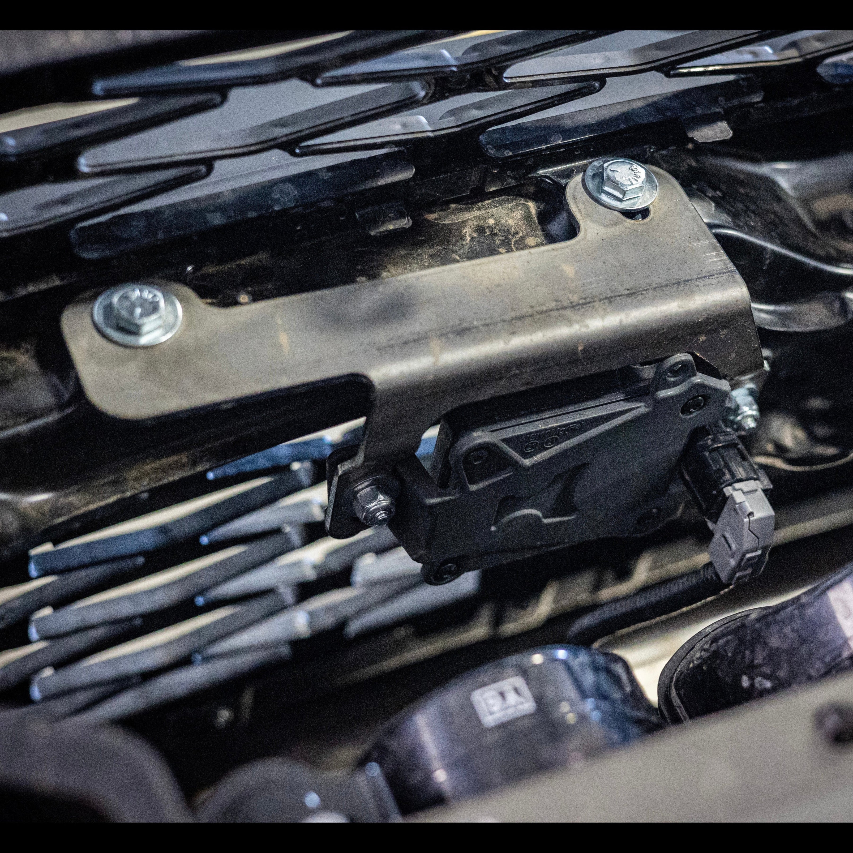 A view from above and behind, showing the properly-installed TSS Relocation Bracket. 