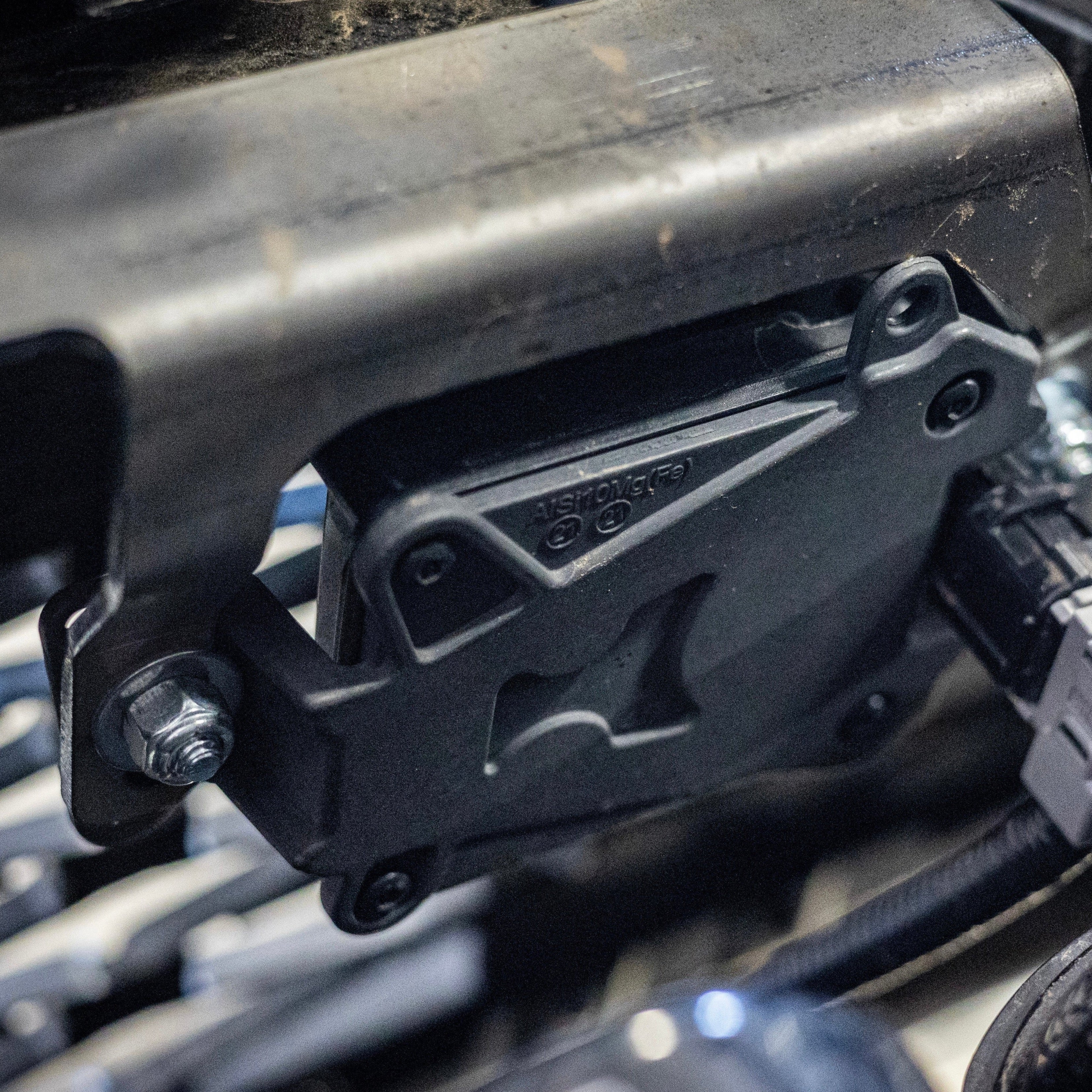 Close-up view of the steel bracket used in C4 Fabrication's TSS Relocation Kit.