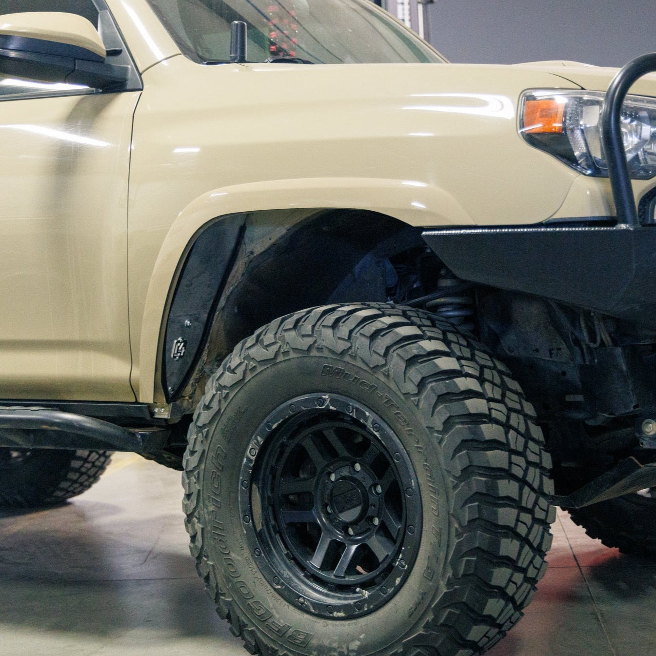 Front quartering view of a tan 4Runner equipped with C4 Fabrication's Oversized Tire Fitment Kit.
