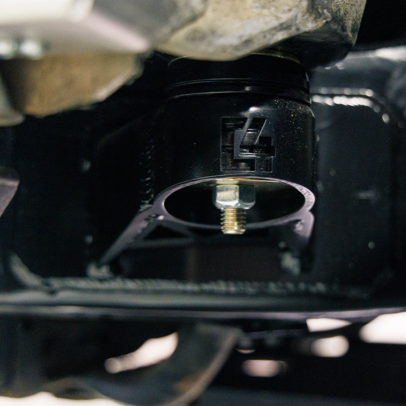 Low angle close-up showing the smaller, relocated C4 body mount included in the complete Oversized Tire Fitment Kit.