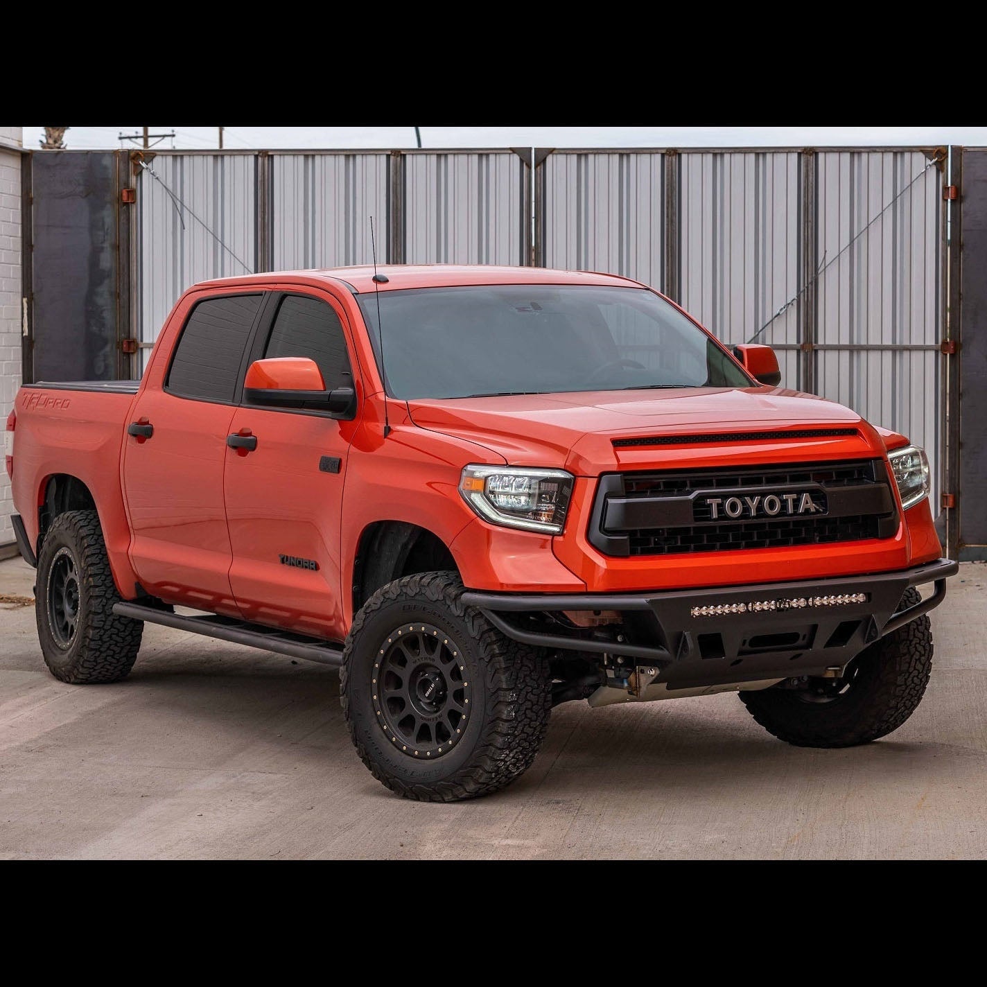 Quartering on photo of a red Tundra CrewMax equipped with the C4 Hybrid bumper. 