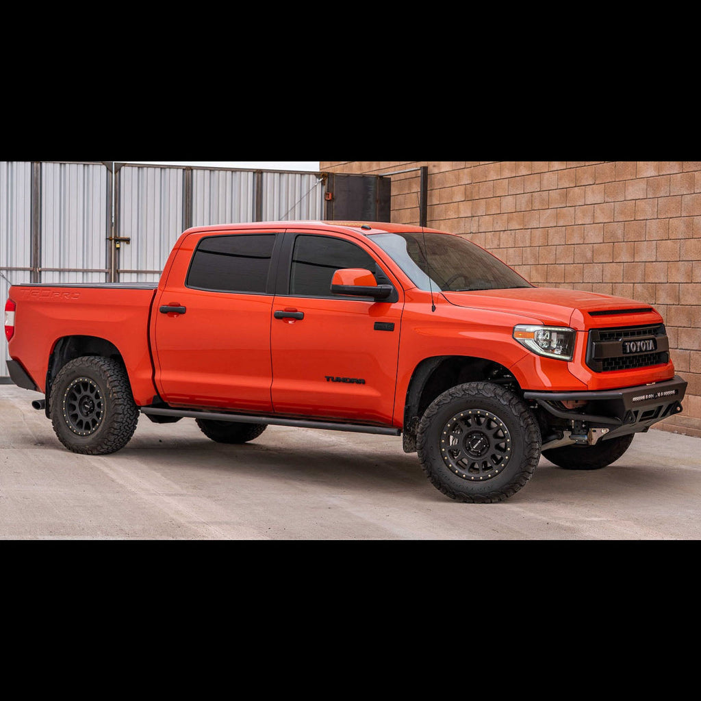 Side angle of the C4 Hybrid bumper installed on a red Tundra Crewmax. 