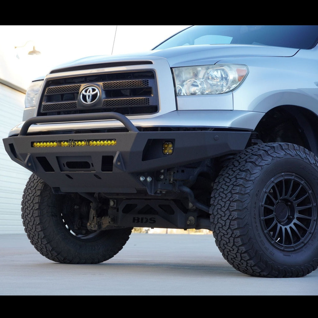 Low quartering photo of the C4 Overland bumper with mid-height bull bar showing the clearance and tow points built into the bumper.