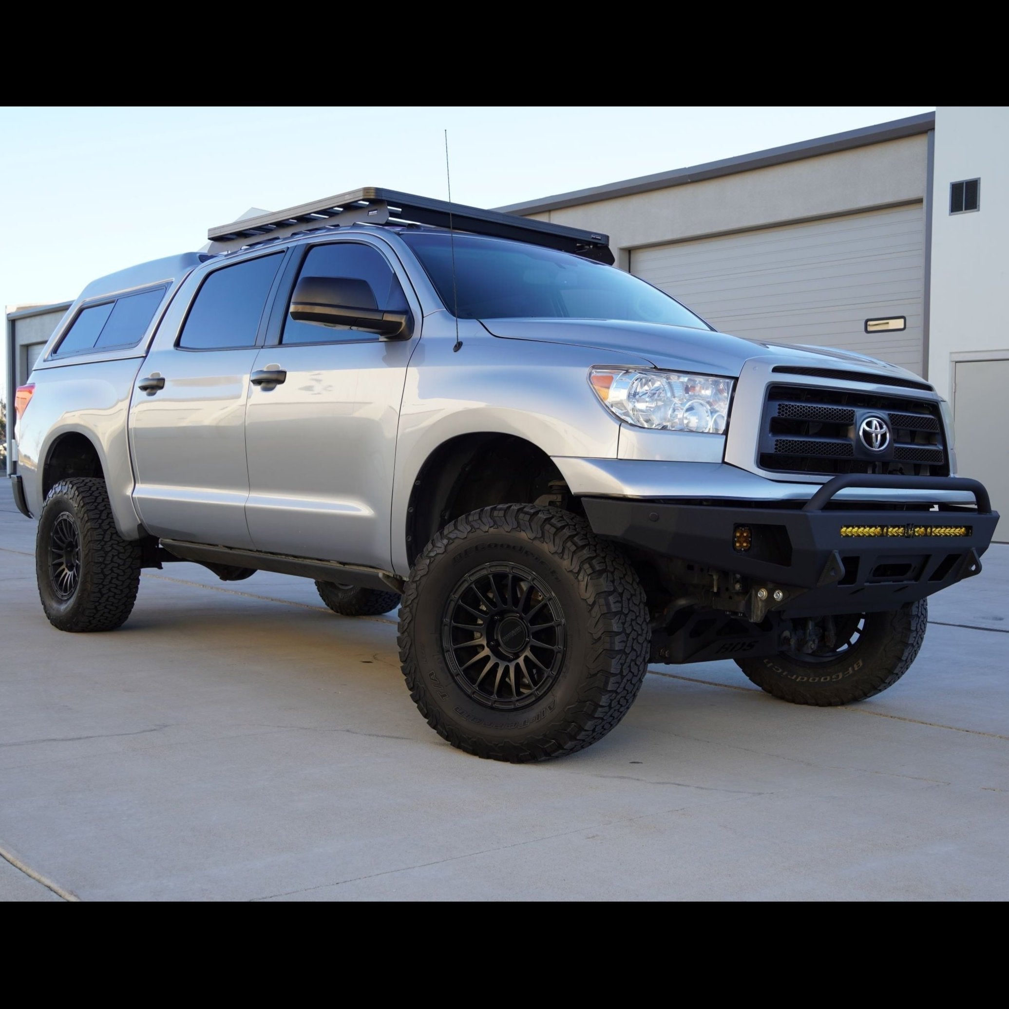 Silver Toyota Tundra CrewMax with a C4 Overland bumper installed. 
