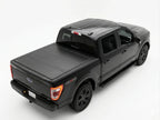 Black pickup truck with a tonneau cover on a white background