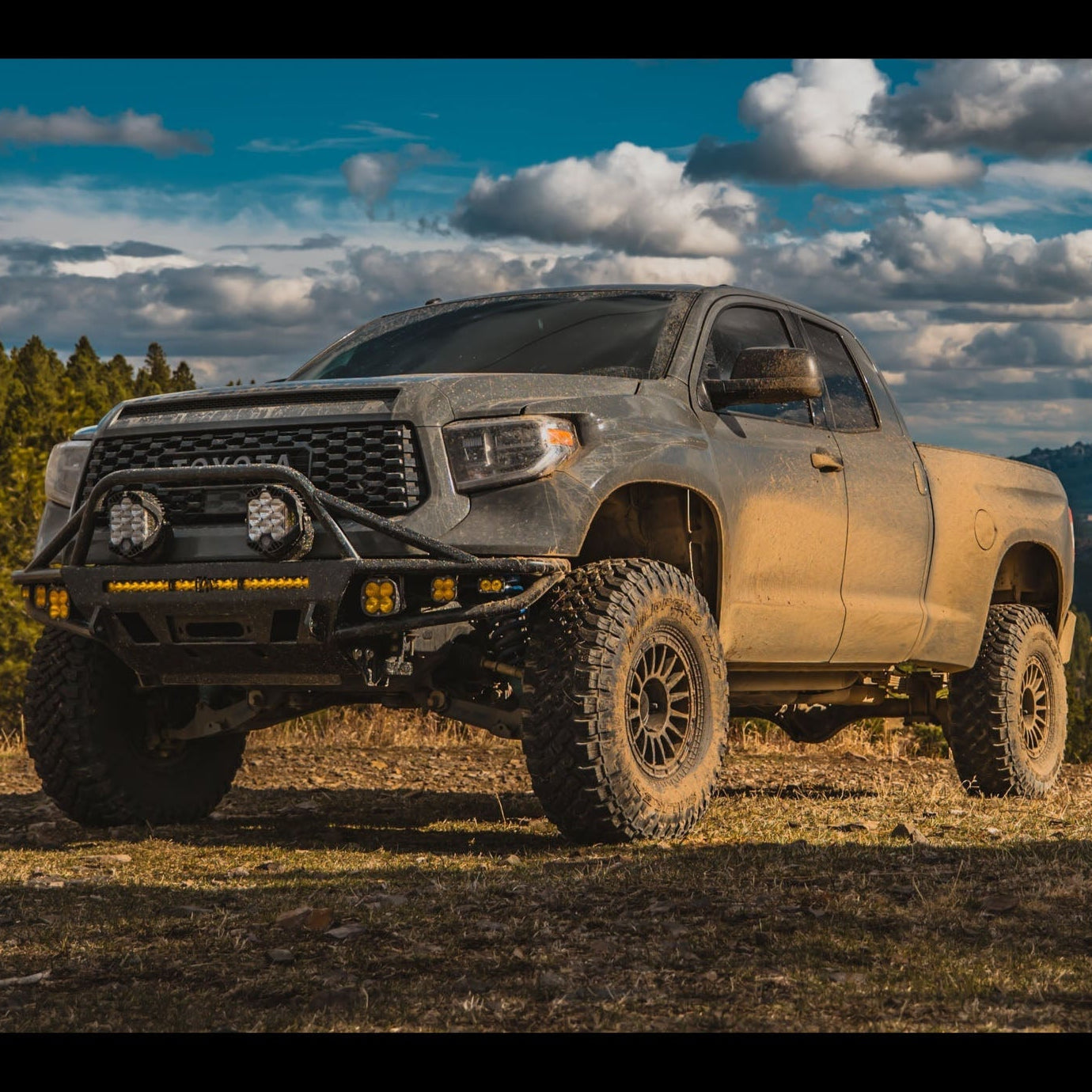 C4 Hybrid bumper installed on a lifted and wide body 2014+ Toyota Tundra Double Cab and equipped with a full array of aftermarket LED lighting. 